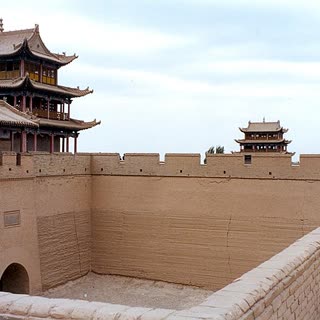 Jiayuguan Fort gate tower with snow peaks behind